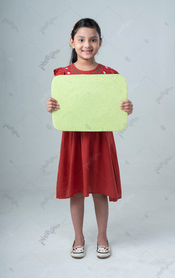 A cute little girl holding a placard