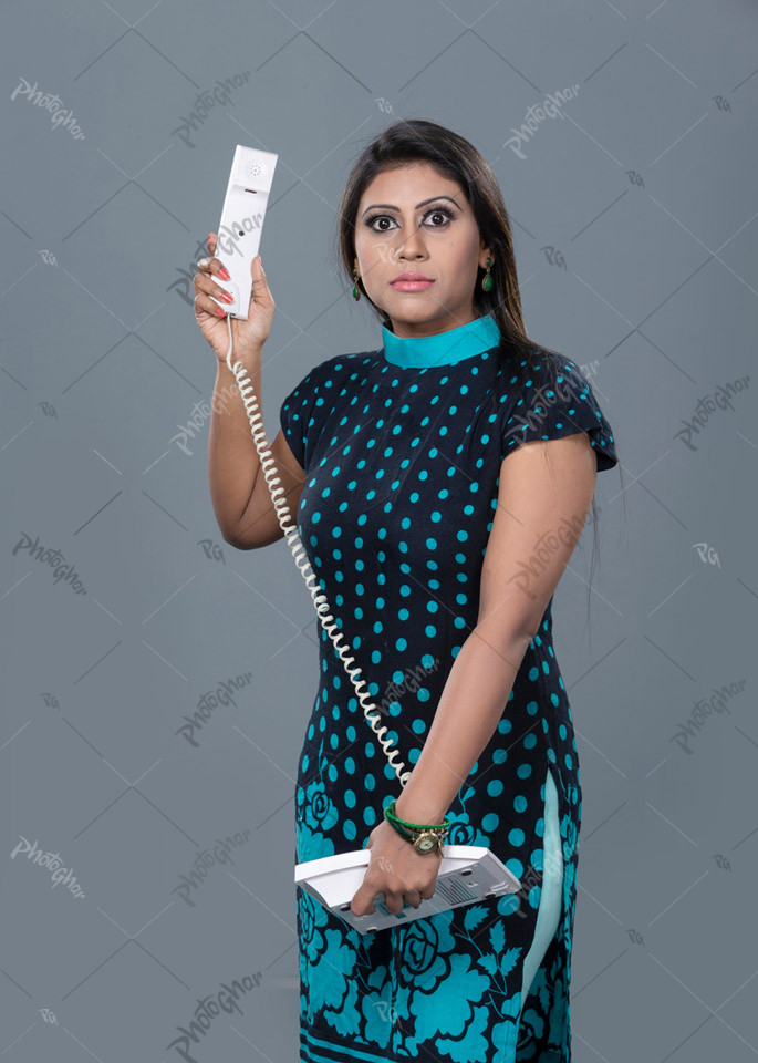 Angry woman holding telephone