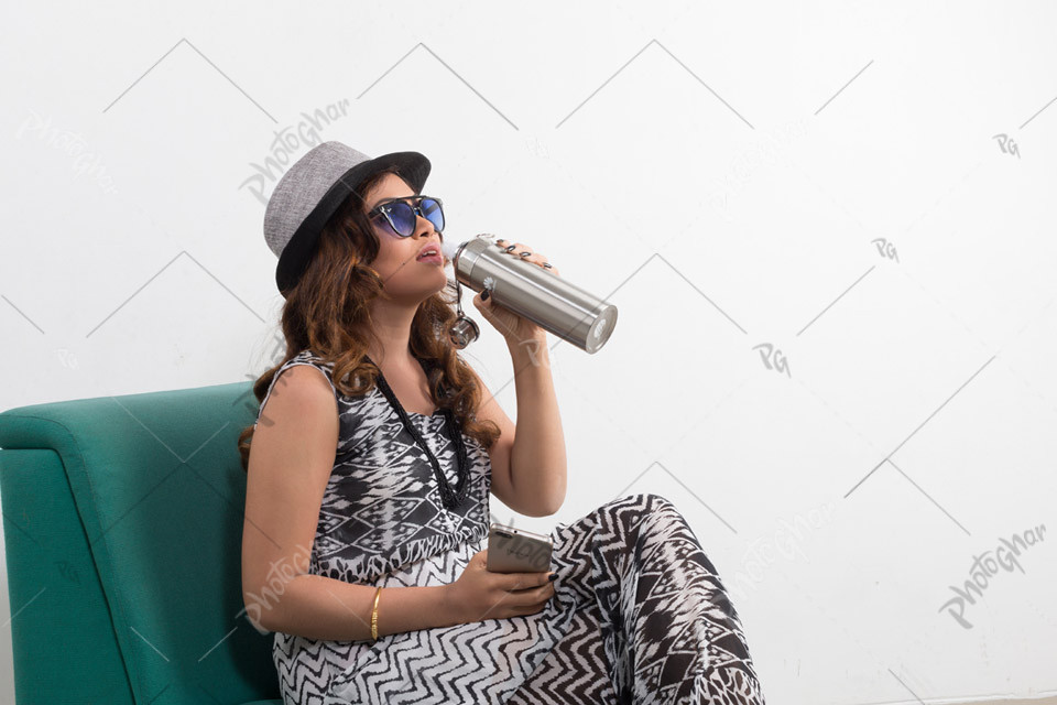 Attractive female traveler drinking water