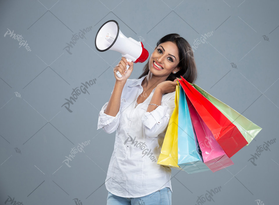 Attractive young woman holding megaphone