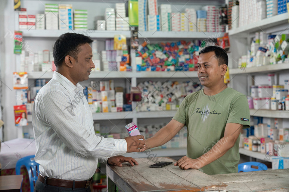 Bangladeshi Customer receiving medicine