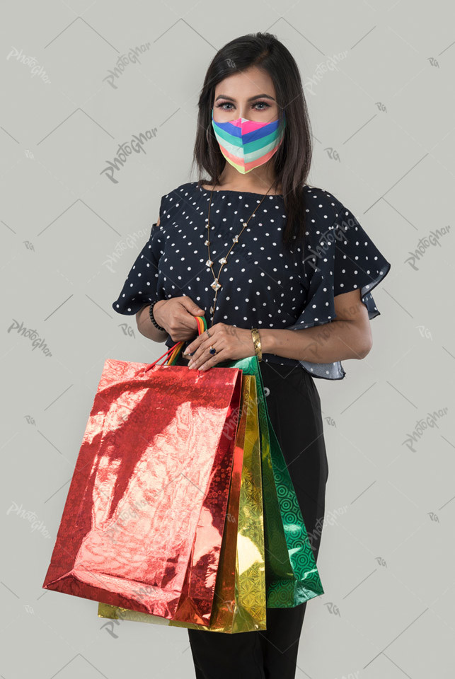 Bangladeshi woman in protective mask with bags