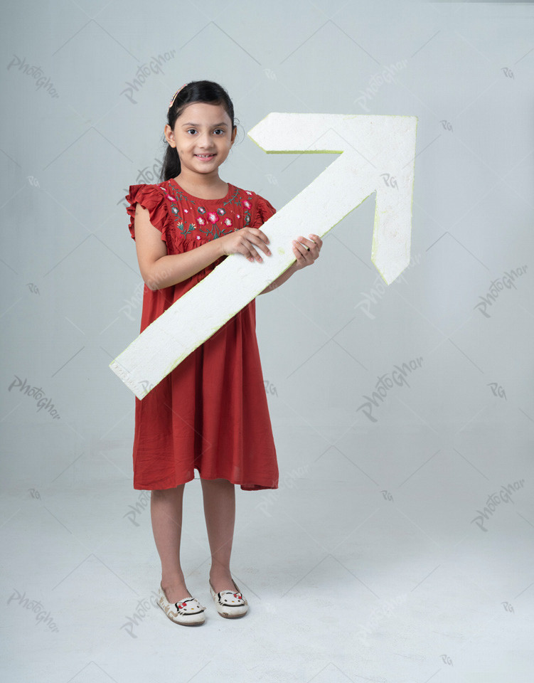 Beautiful child with direction arrow sign pointing up