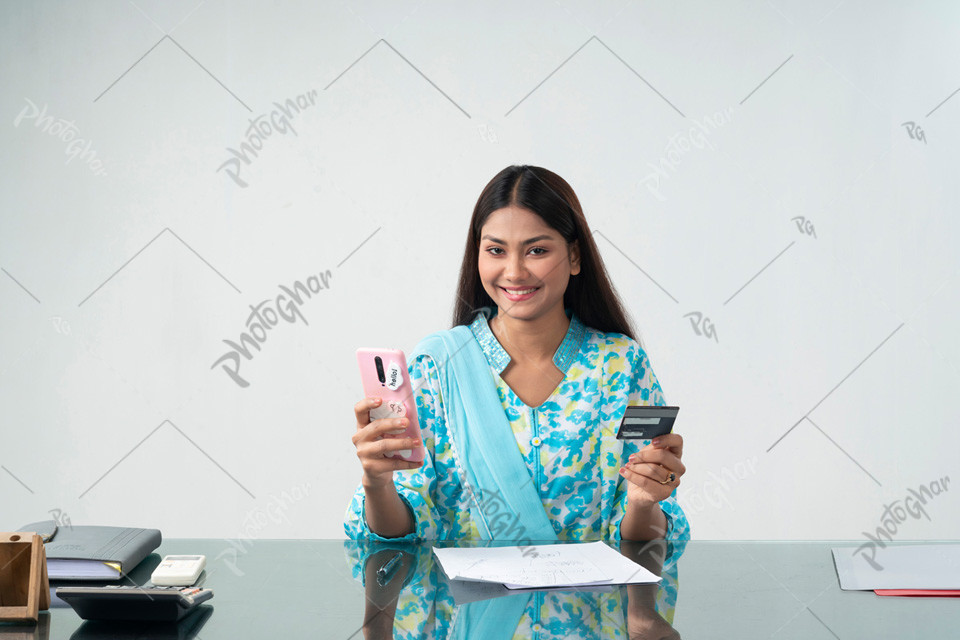 Beautiful happy girl holding credit card