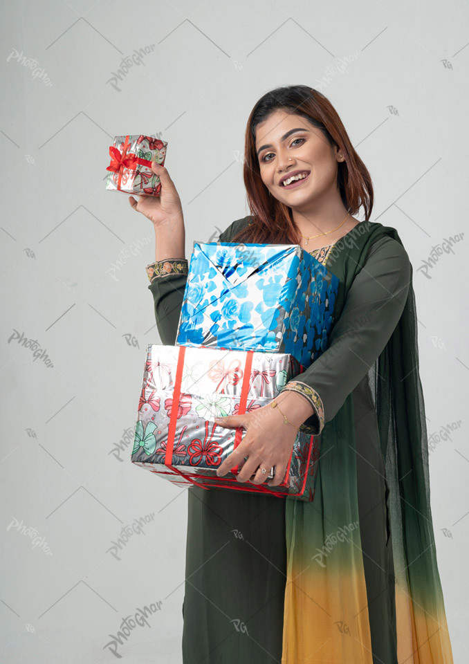 Beautiful smiling woman showing gift boxes