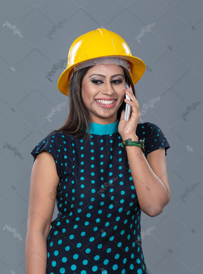 Beautiful woman engineer talking on phone