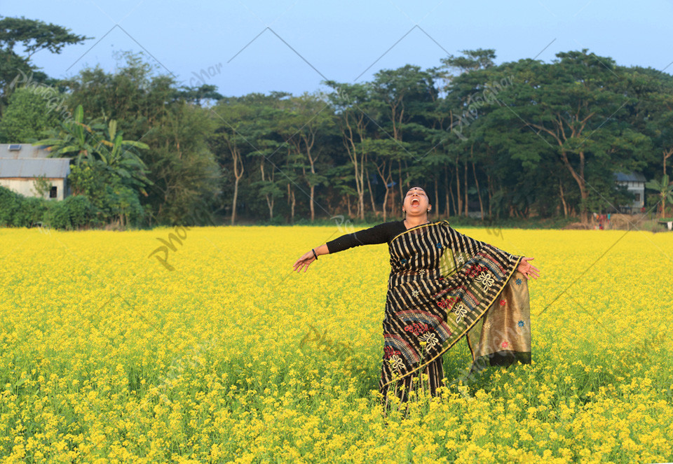 Beautiful woman in mustard field