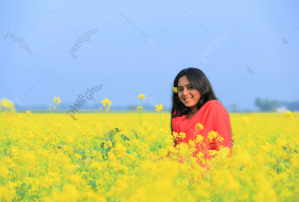 Beautiful young girl in the mustard field