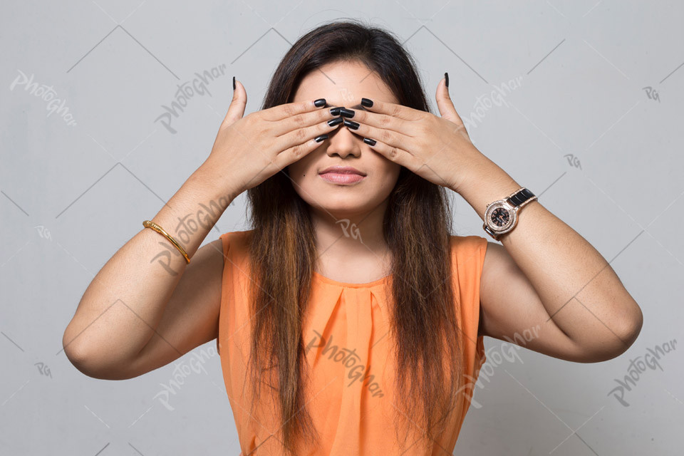 Beautiful young modern lady covering her eyes