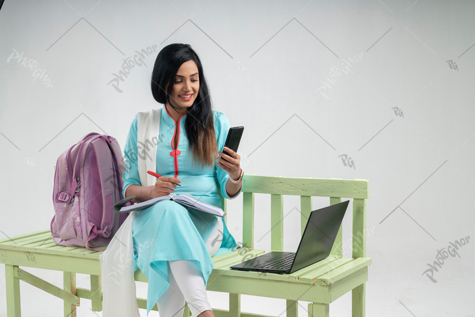 Cheerful Bangladeshi woman student using laptop