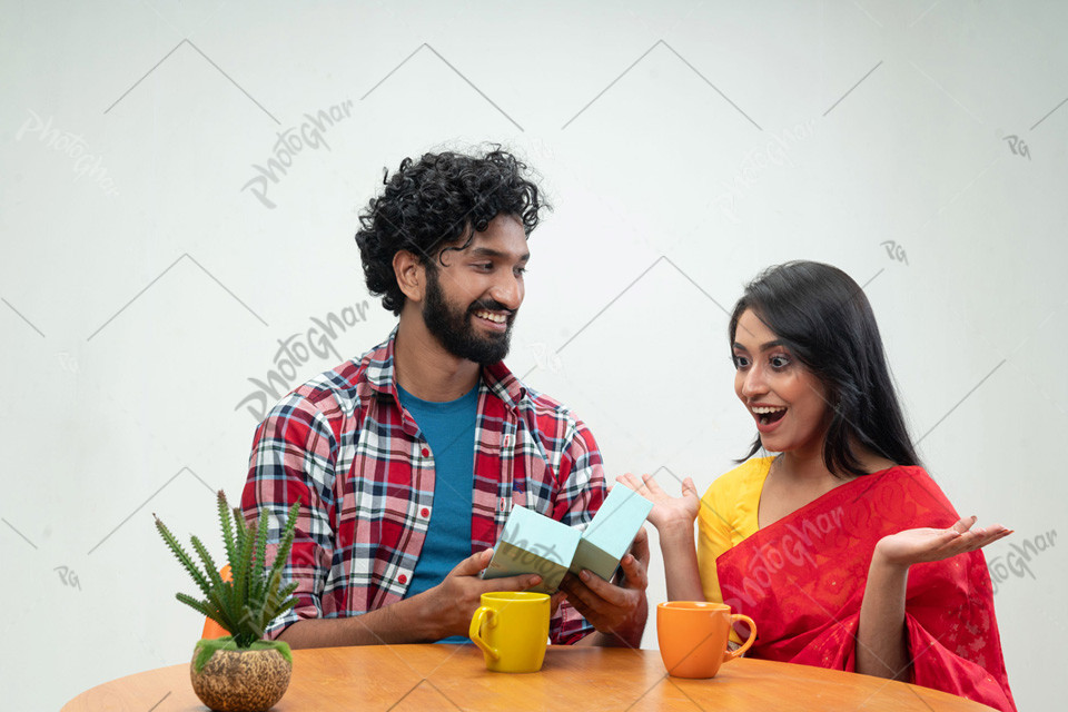 Cheerful Couple Exchanging Gifts