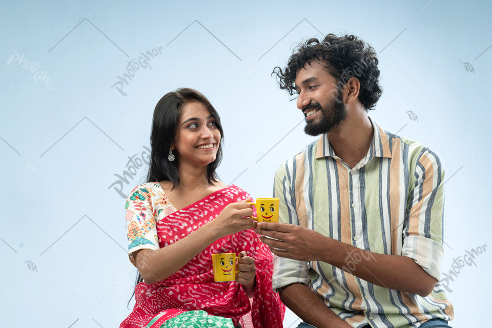 Cheerful couple holding coffee mugs