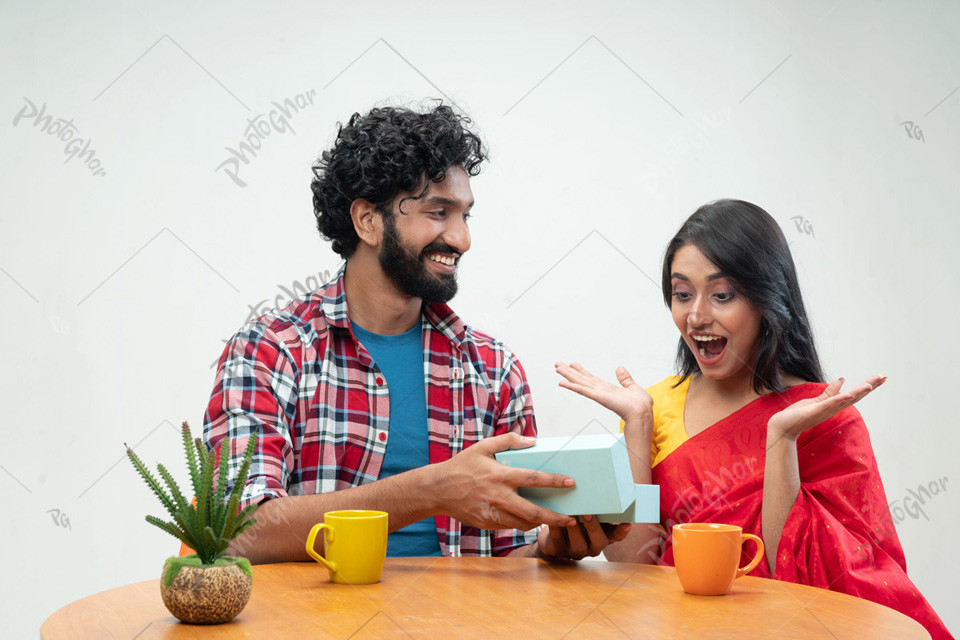 Cheerful man presents gift box