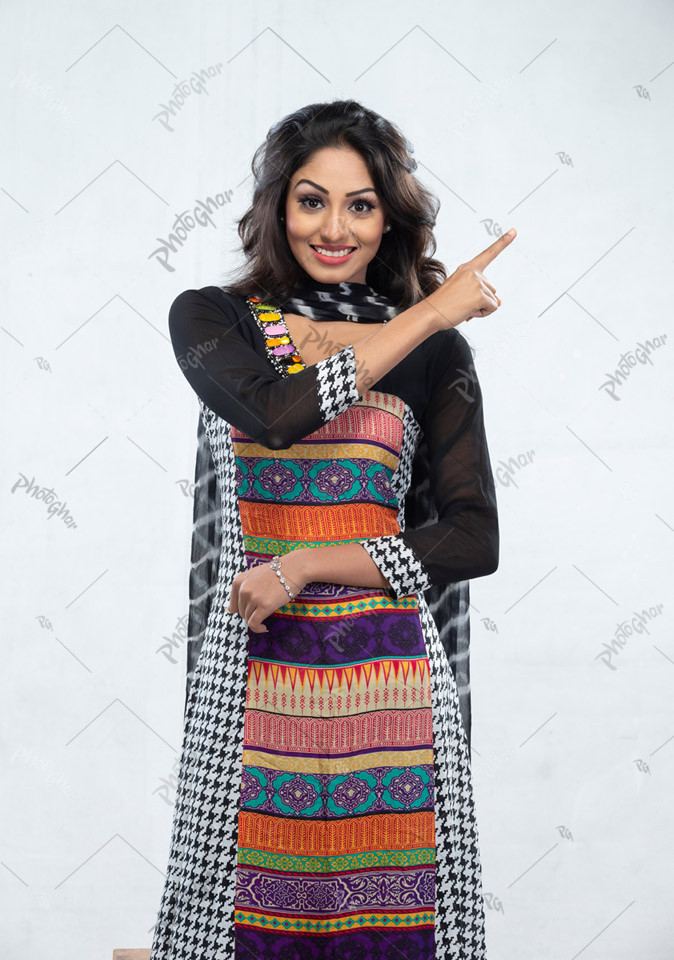 Confident smiling beautiful woman pointing left