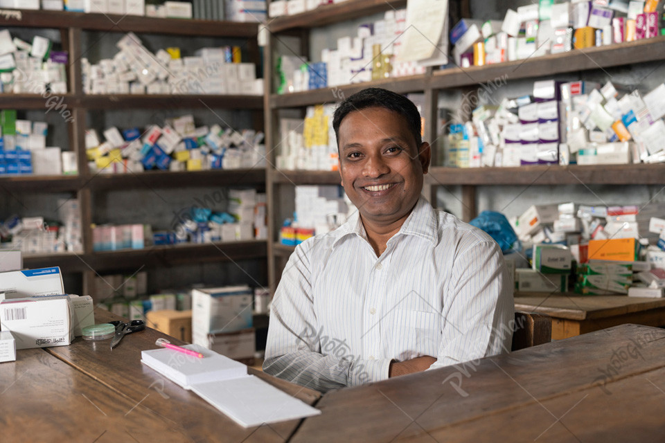 Confident smiling village pharmacist