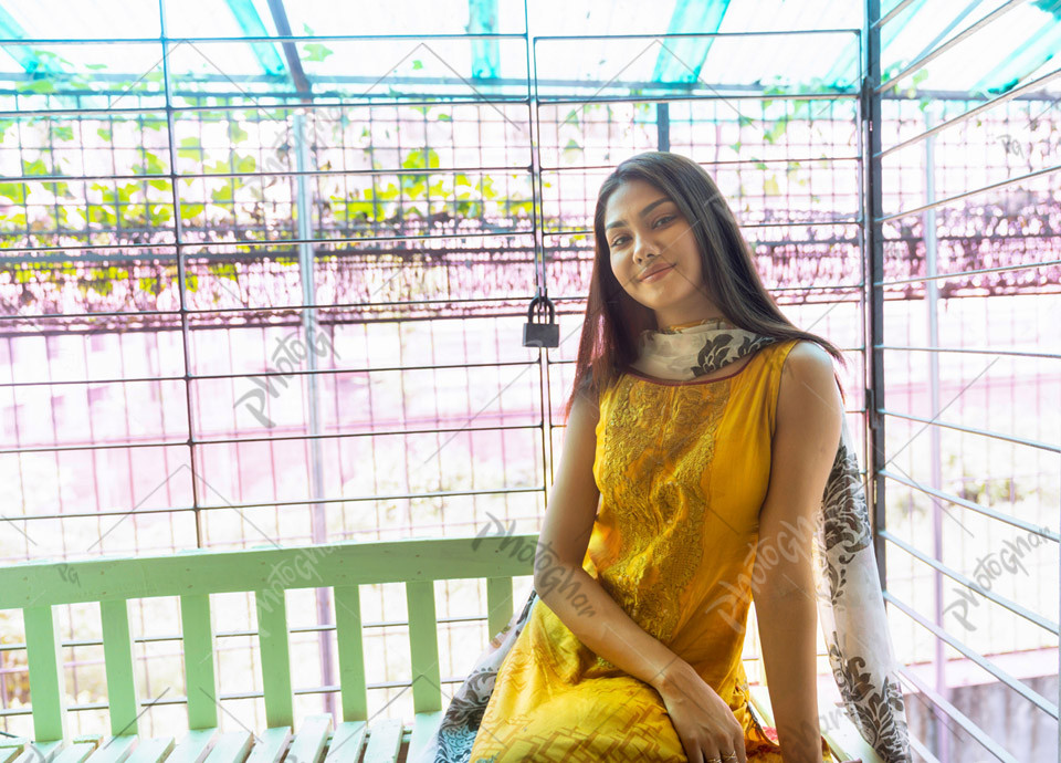 Confident young girl sitting happily