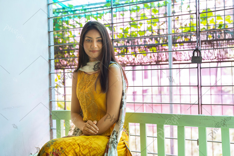 Confident young woman sitting at balcony