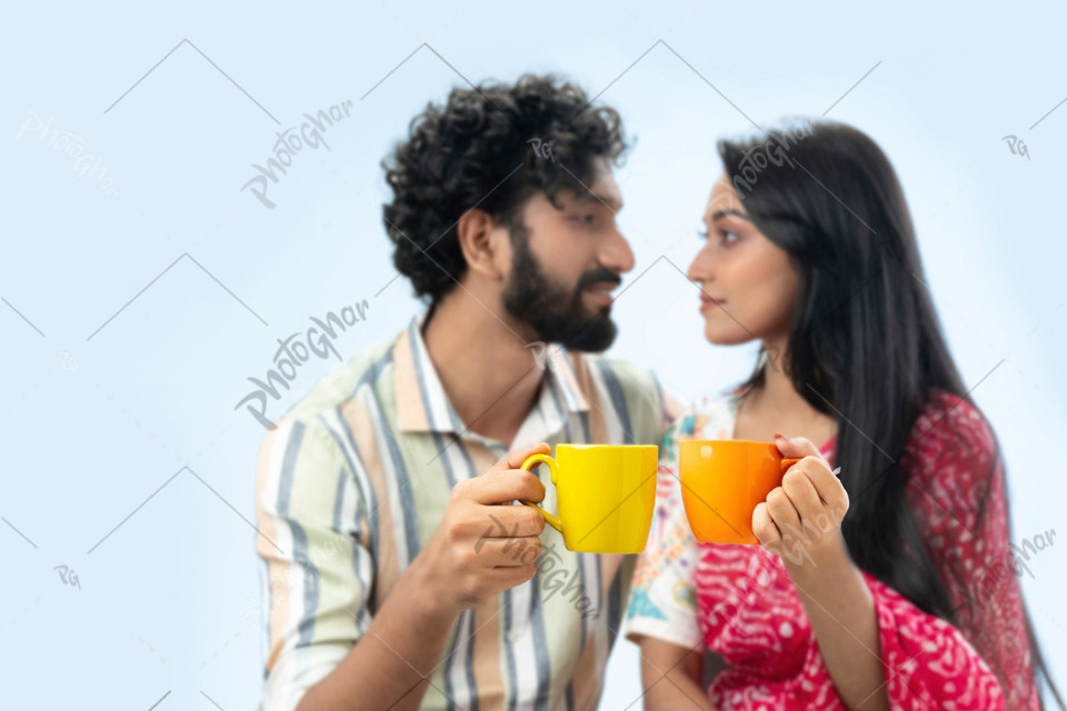 Couple holding coffee mugs