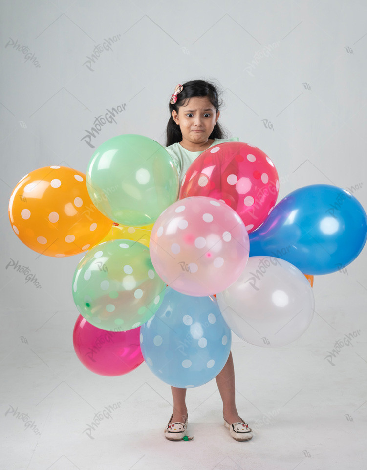 Excited Beautiful child holding colorful balloon