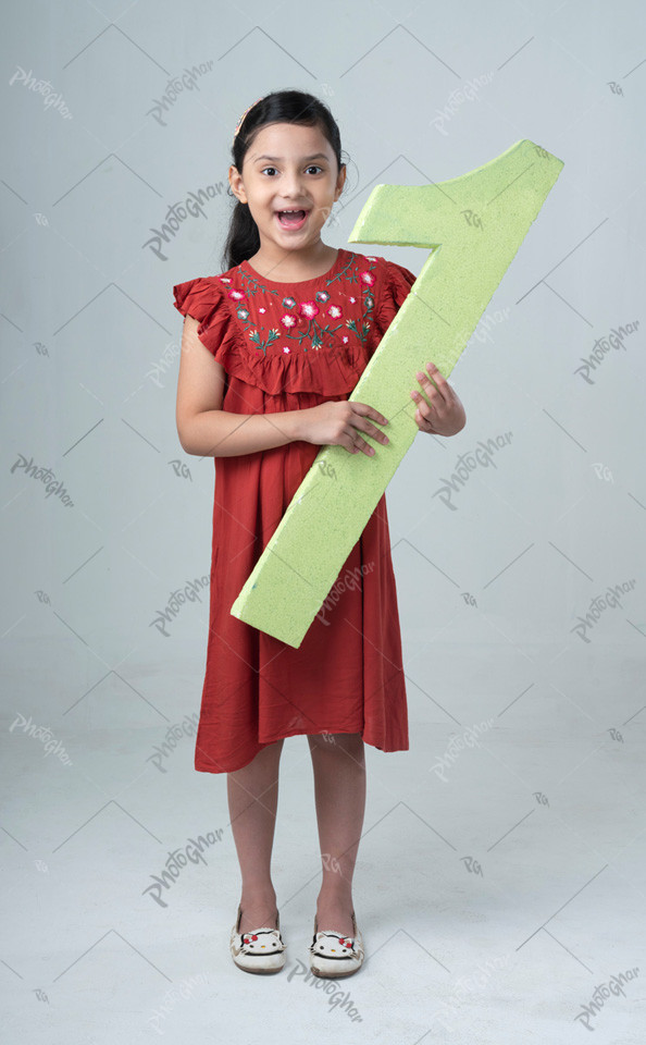 Excited child holding and showing number one cutout