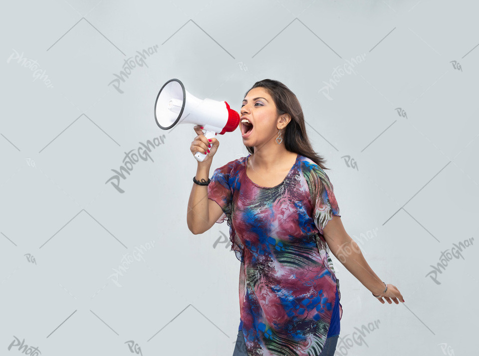 Excited female shouting with megaphone