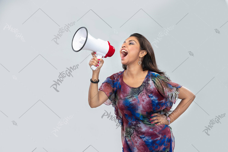 Excited woman passionately shouts into megaphone