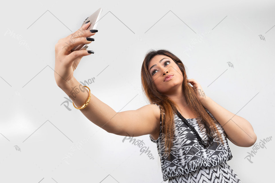 Fashionable woman taking selfie