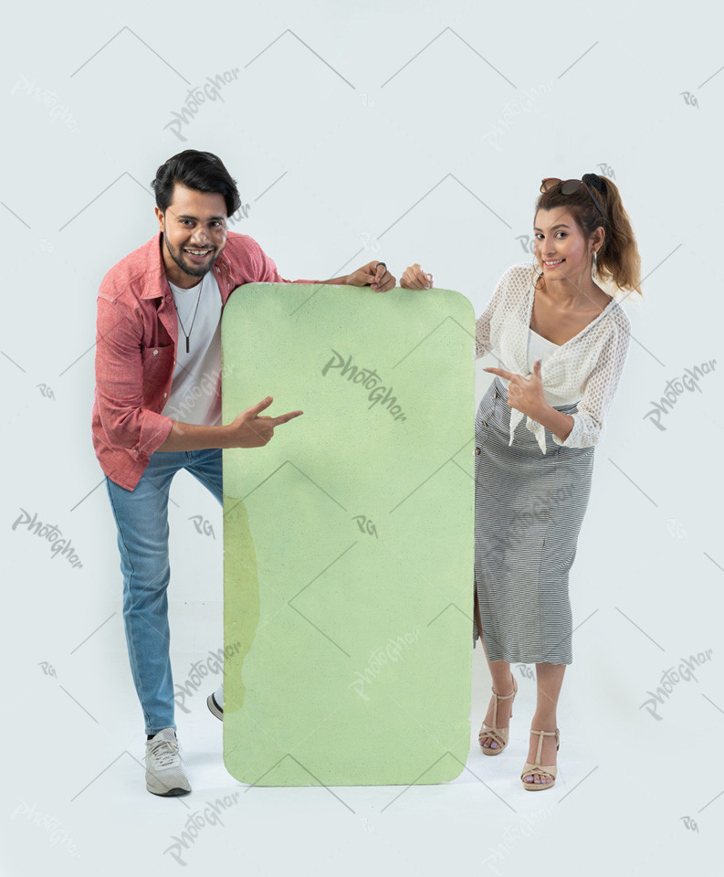 Fashionable young couple pointing at placard