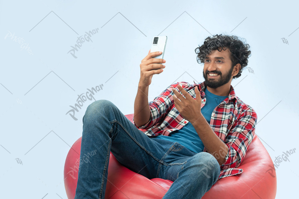 Fashionable young man taking selfie