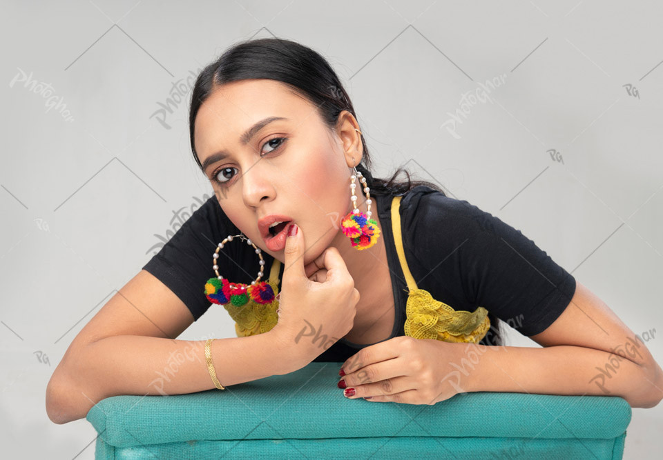 Gesturing Woman with Hand on Lip