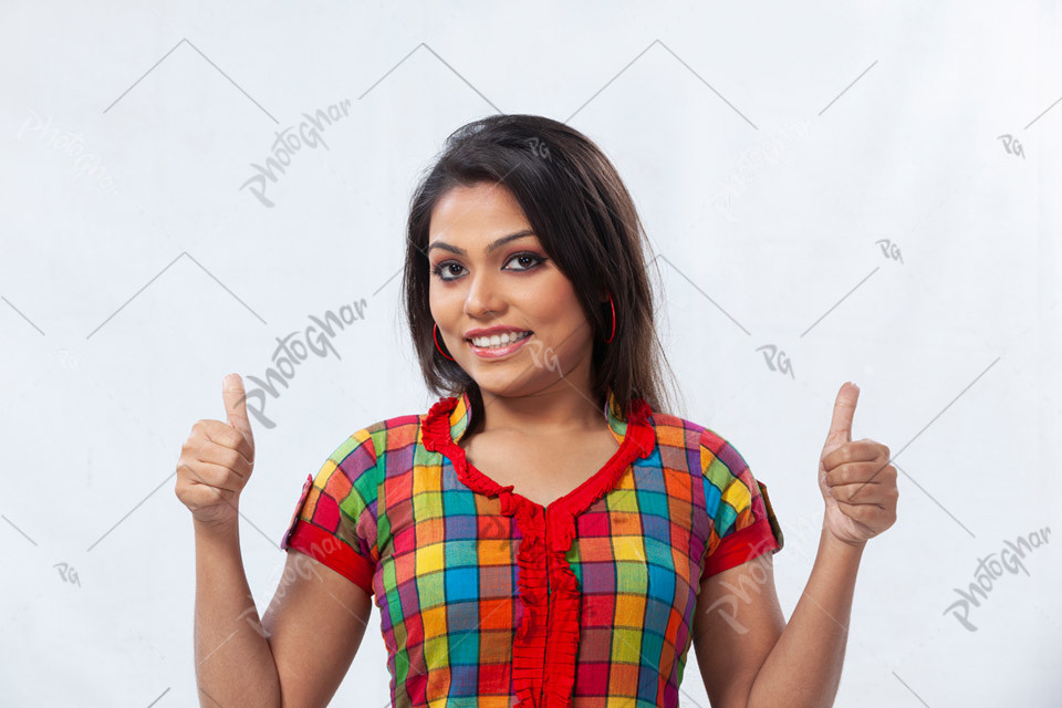 Happy Bangladeshi young girl showing thumbs up