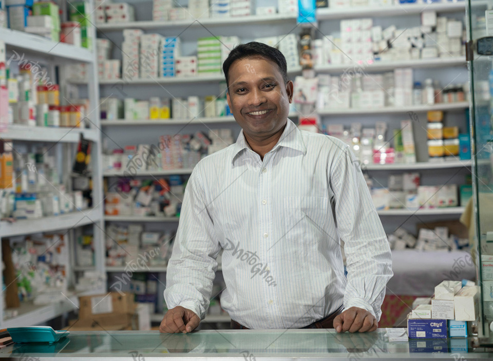 Happy Confident smiling salesman in village pharmacy