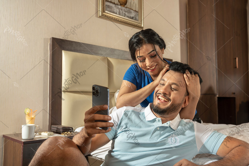 Happy Couple Capturing Moments in Luxury Hotel Room