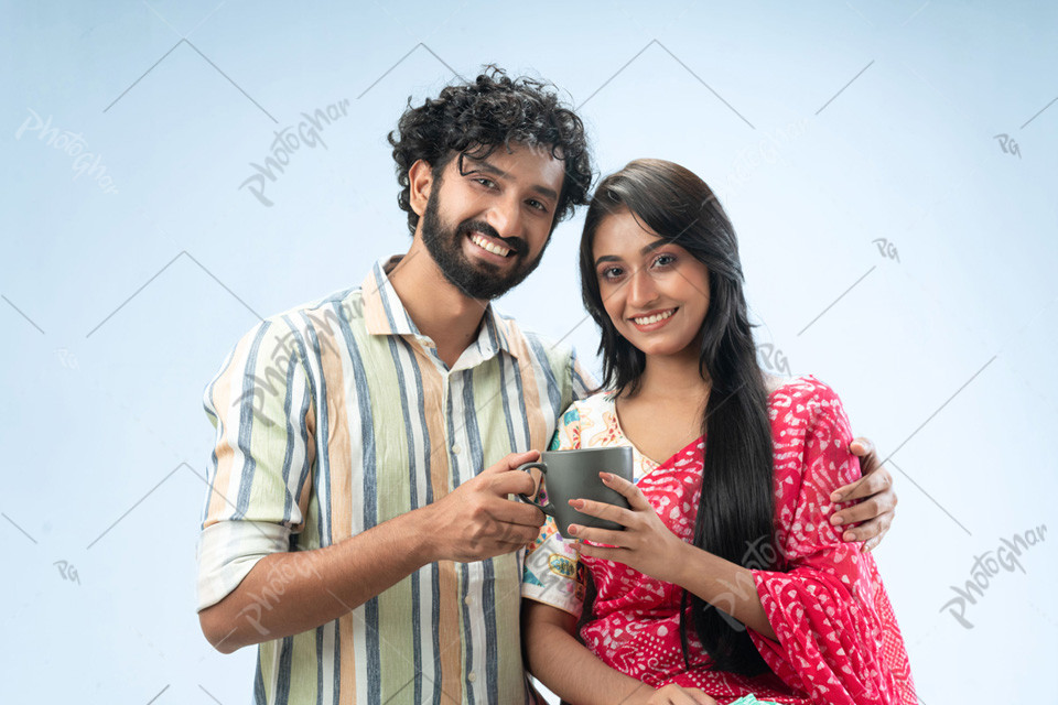 Happy couple holding coffee mug