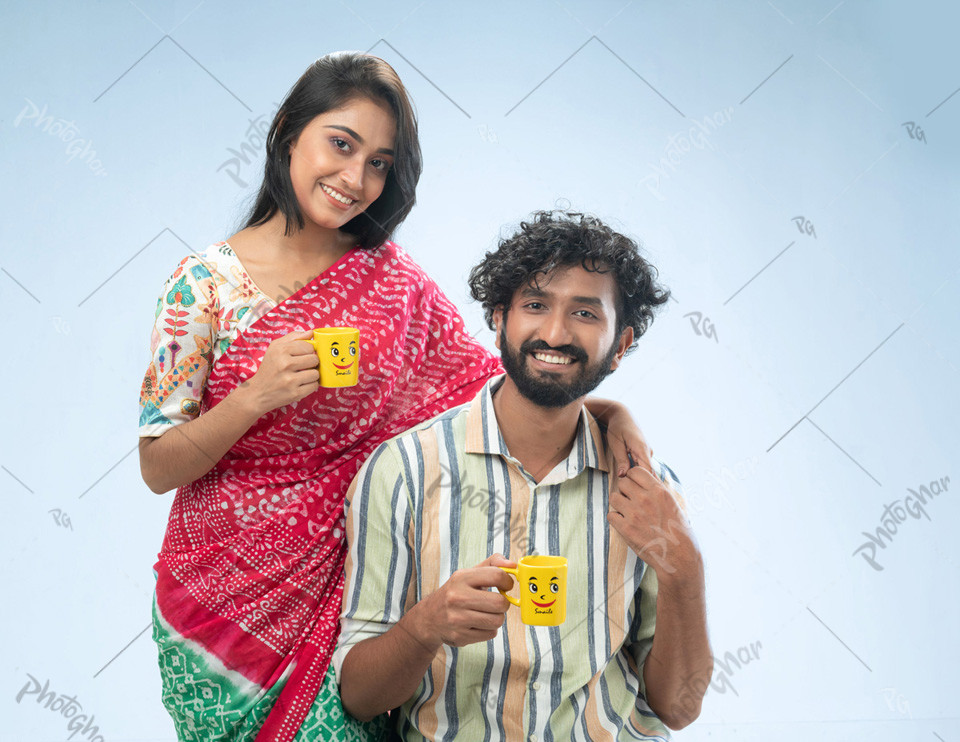 Happy couple holding coffee mugs