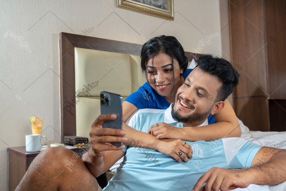 Happy couple watching offers on smartphone