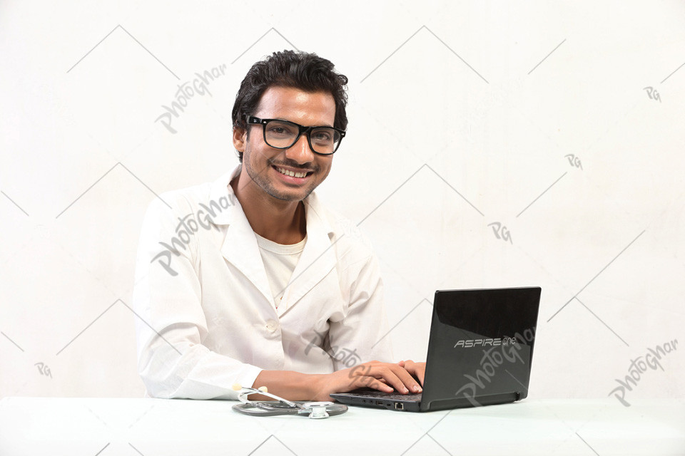 Happy doctor sitting at desk