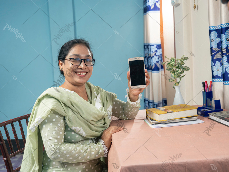 Happy female school teacher using mobile app