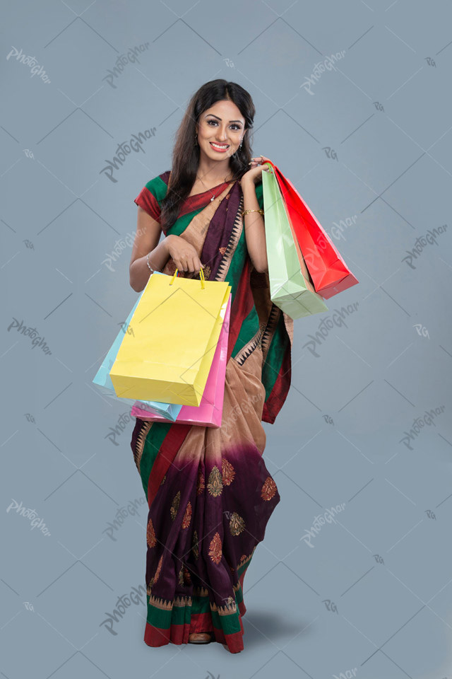 Happy housewife carrying shopping bag