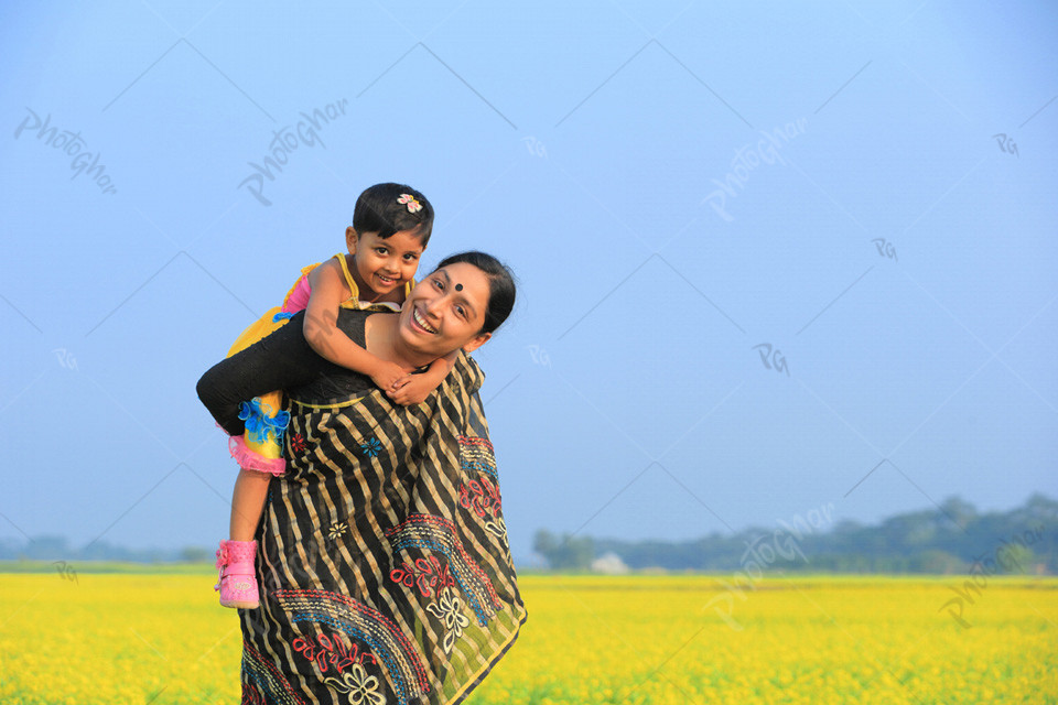 Happy mother holding her baby on backside