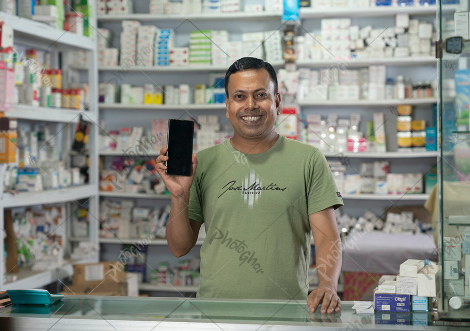 Happy salesman in dispensary using mobile