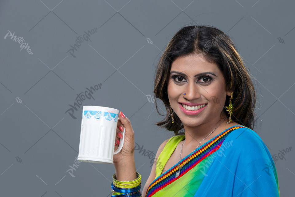 Happy smiling beautiful lady holding water mug