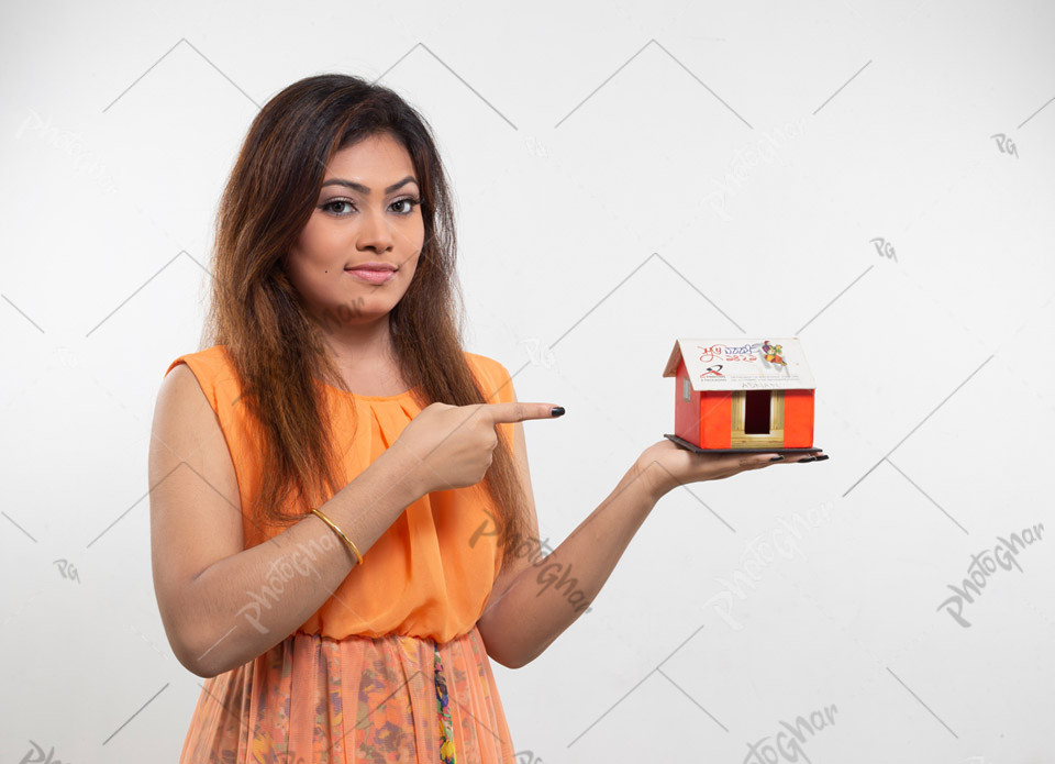 Happy smiling housewife pointing at dream house