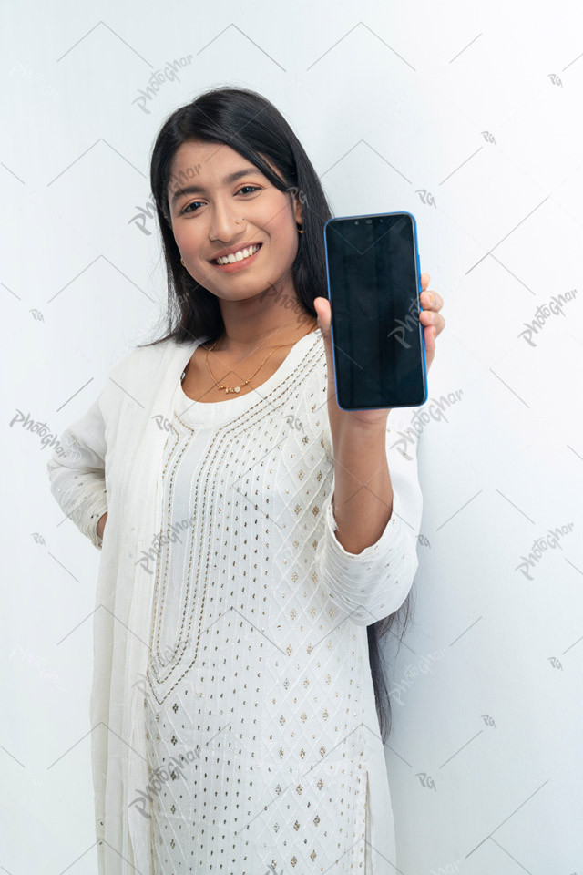 Happy smiling young girl showing mobile screen