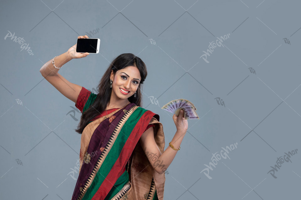 Happy woman holding banknote and smartphone