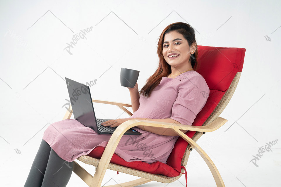 Happy woman holding coffee with laptop