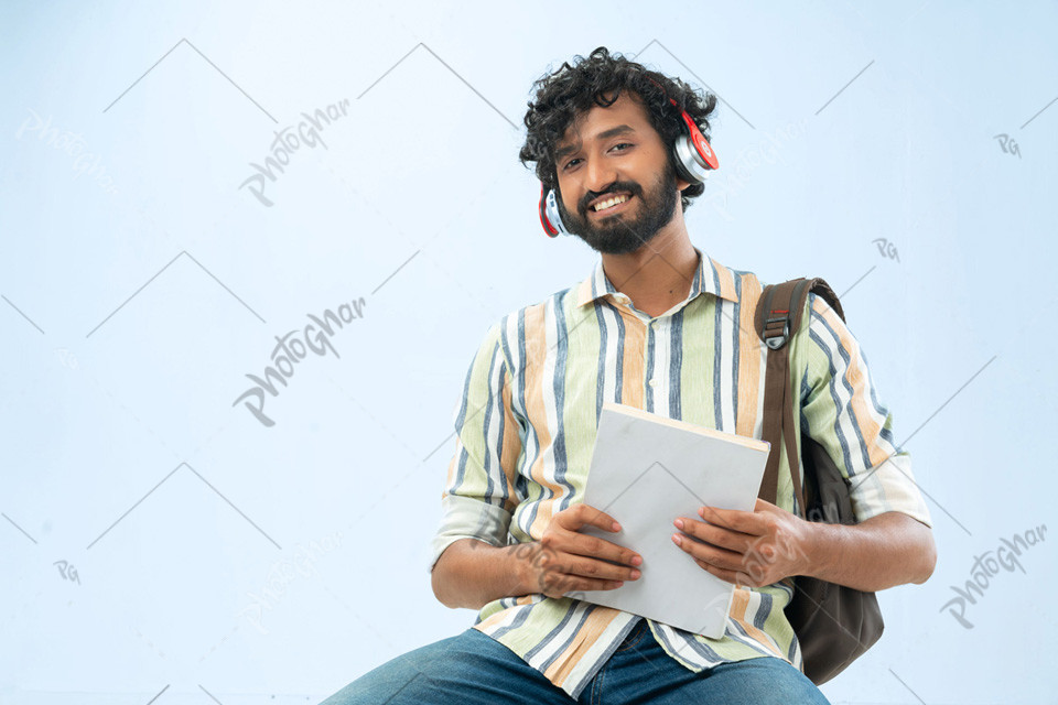 Happy young boy holding book