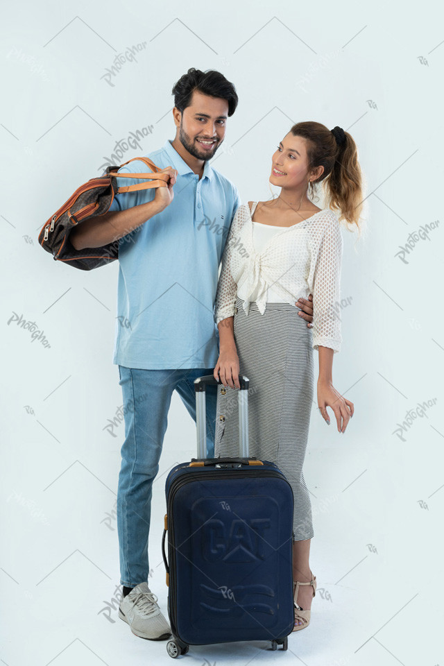 Happy young couple traveler holding suitcase