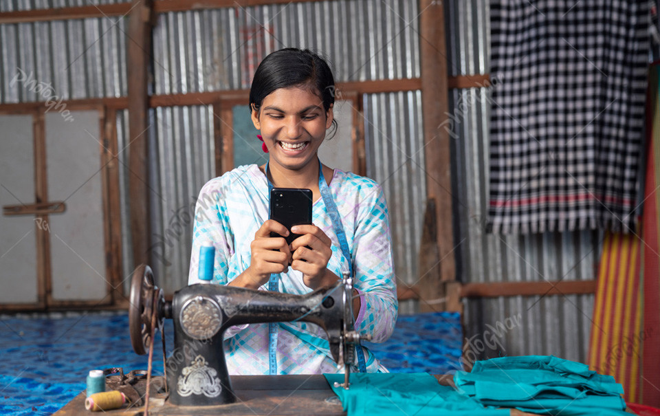 Happy young girl dressmaker using an online payment