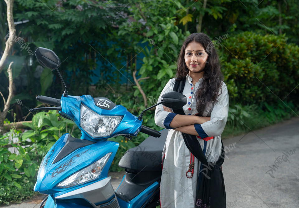 Happy young girl standing near Scooty Motorcycle